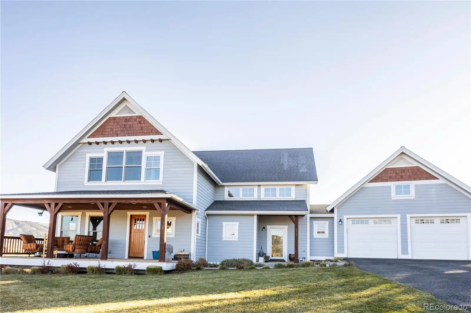 Front exterior of 22 Callie Clark Court, a gray Craftsman with a covered porch