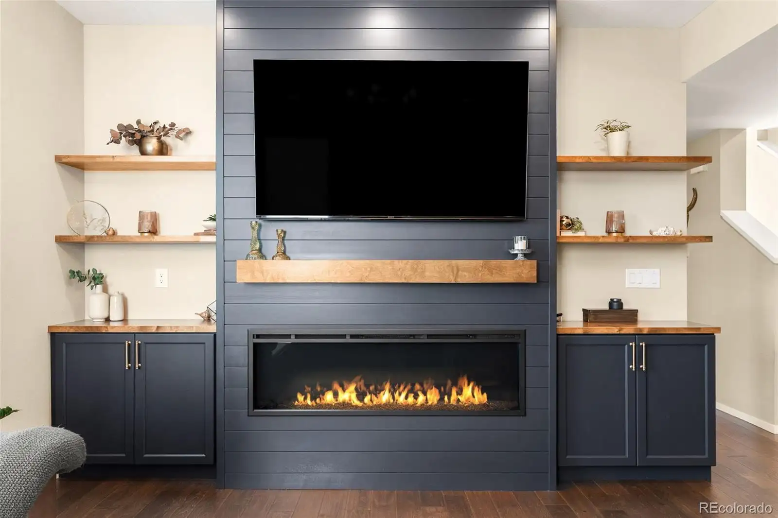 Great room with a linear fireplace and built-in shelving