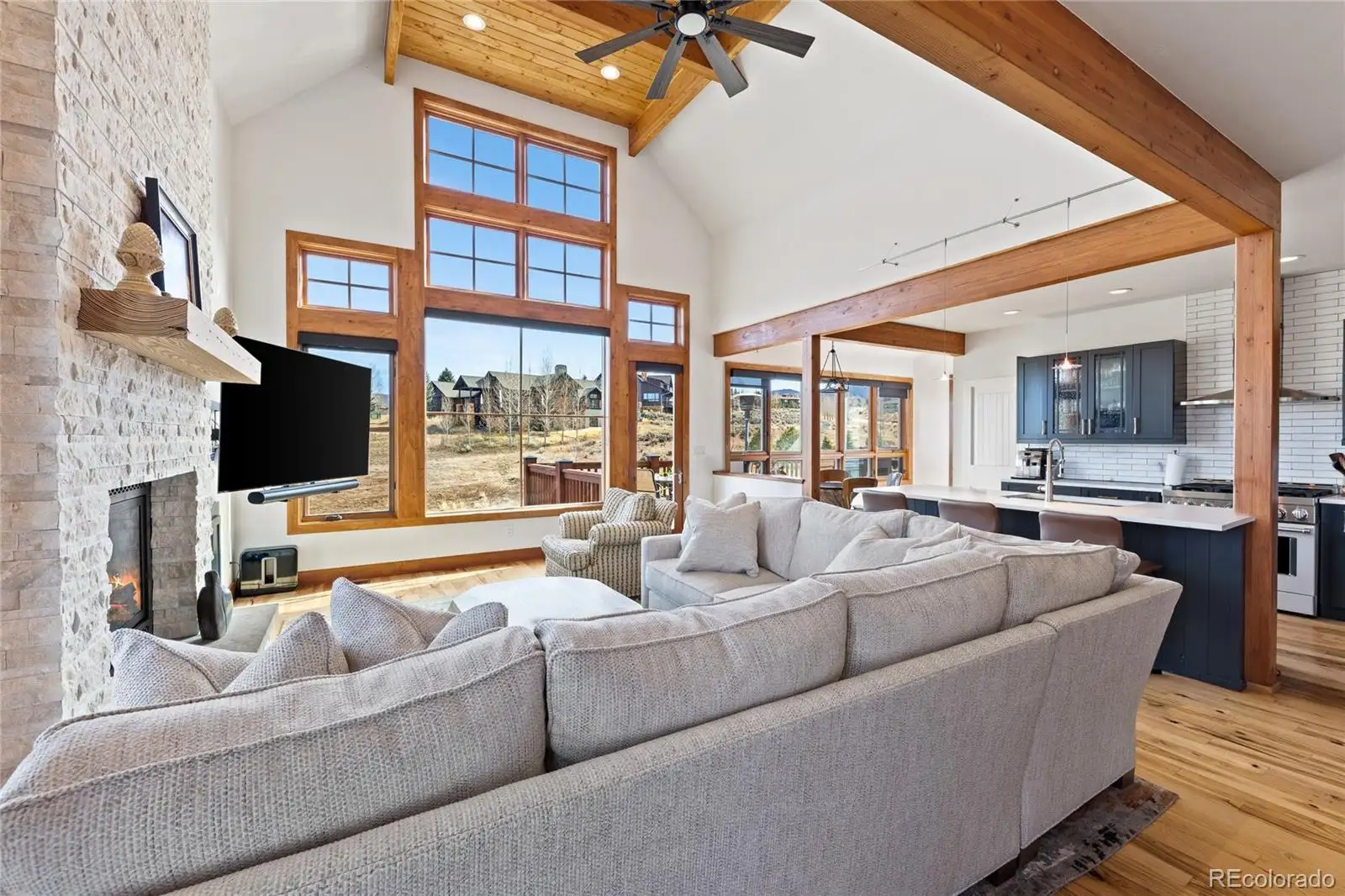 Great room looking toward the kitchen, with timber beams overhead