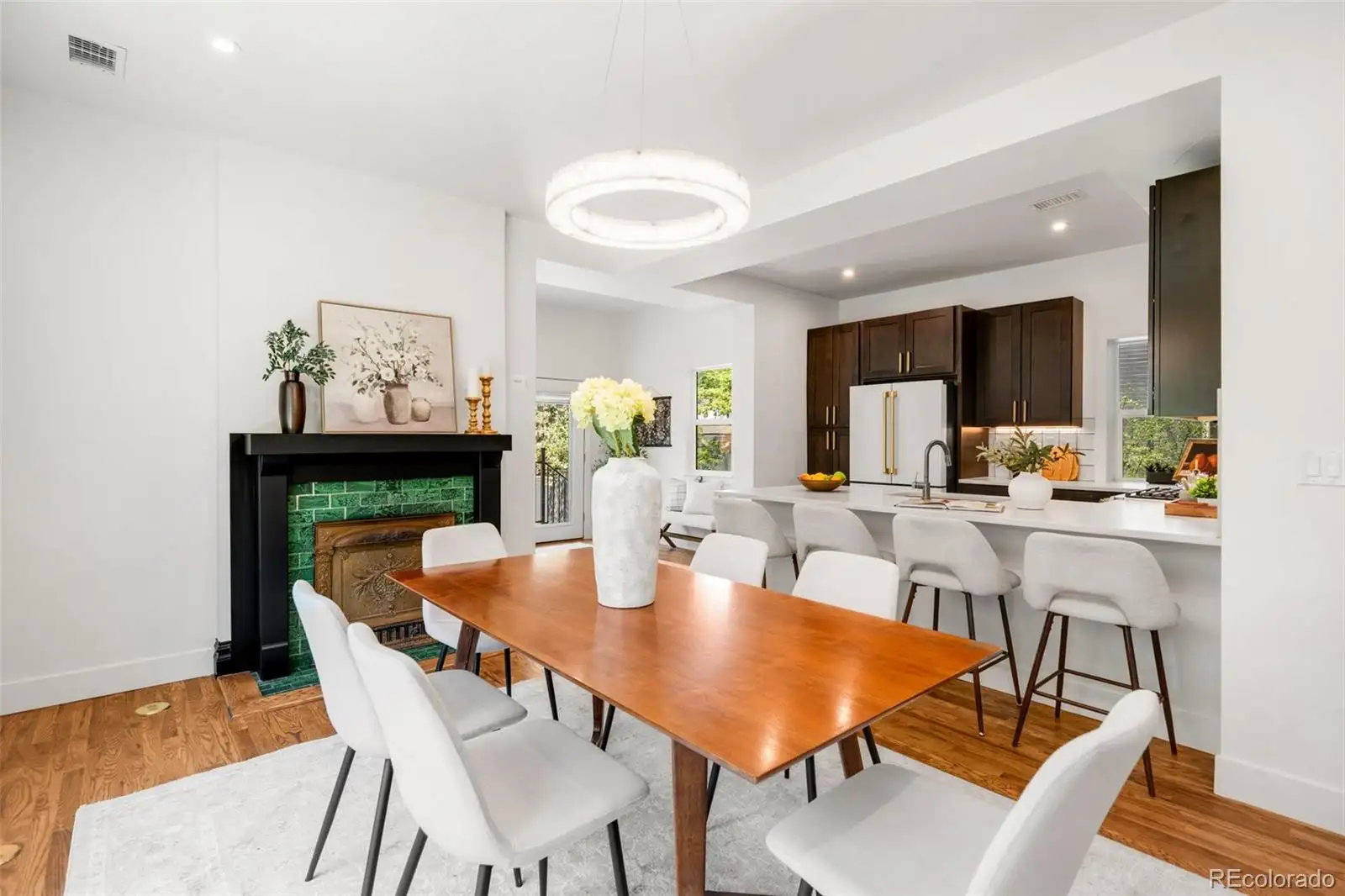 Dining area with a fireplace and wood table