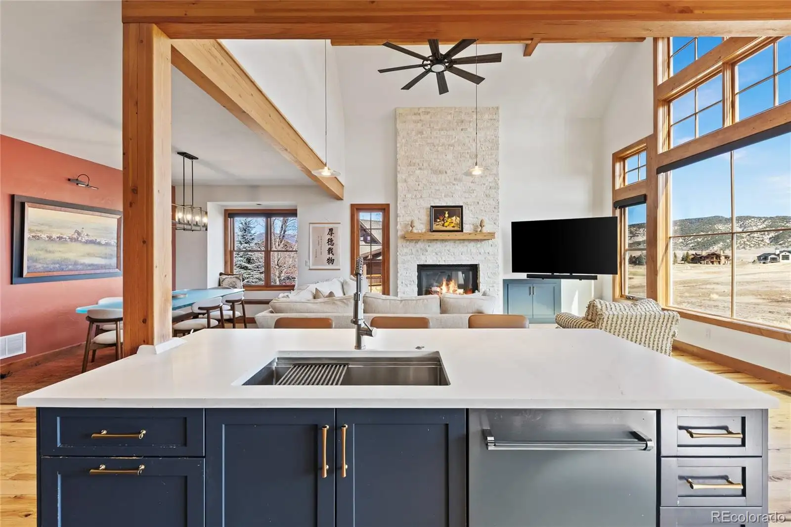 Kitchen island and sink looking across to the great room fireplace