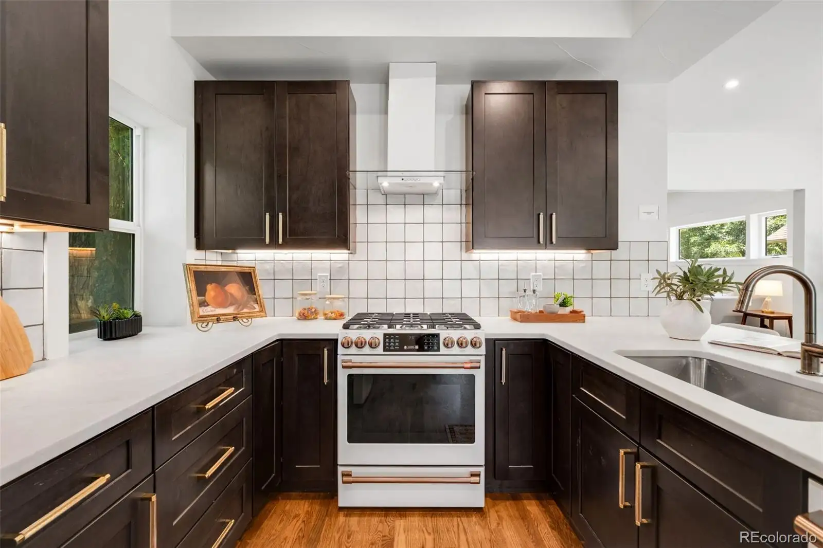 Kitchen with dark cabinetry and a stainless range