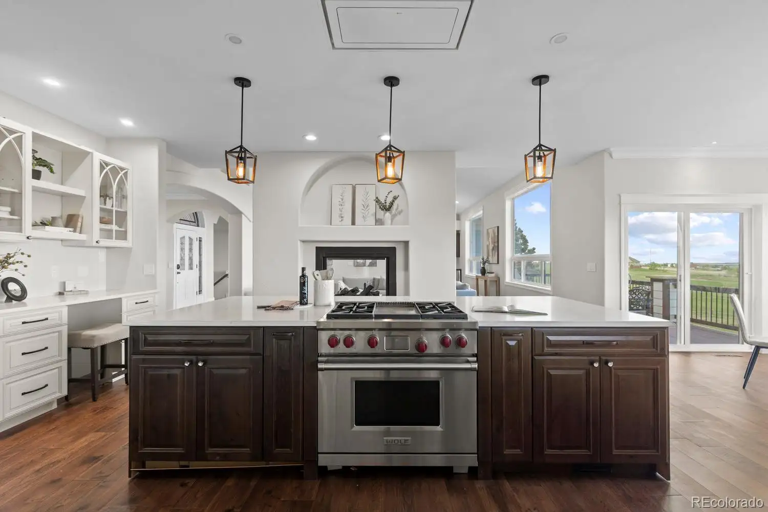 Kitchen with a dark island and professional range