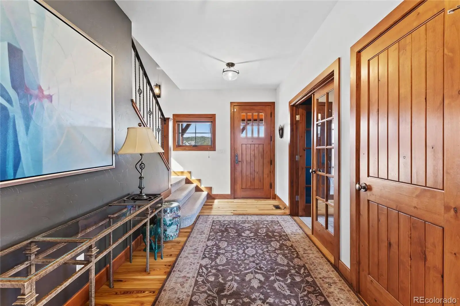 Entry hall with knotty alder doors and the staircase beyond