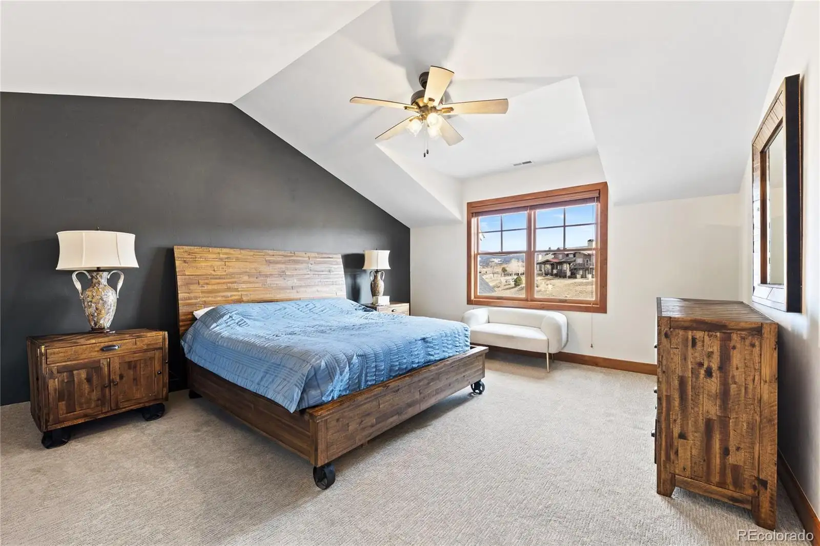 Primary bedroom with a charcoal accent wall