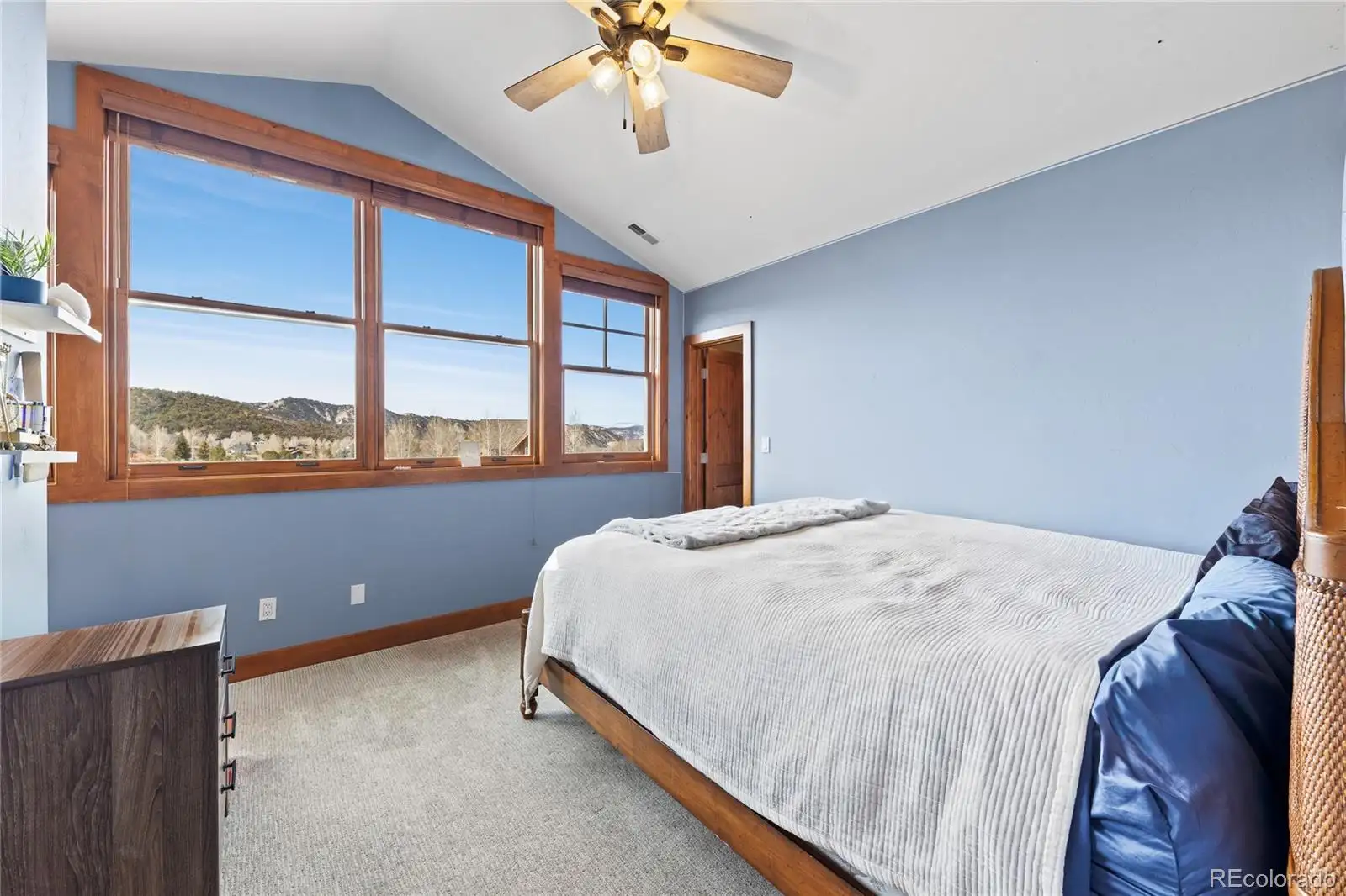 Upper-level bedroom with corner windows